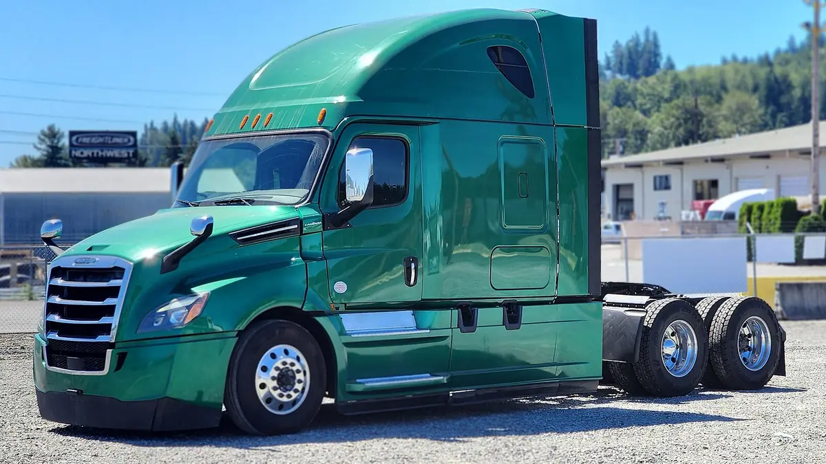 Green 2020 Freightliner Cascadia 126 sleeper tractor parked at a dealer lot