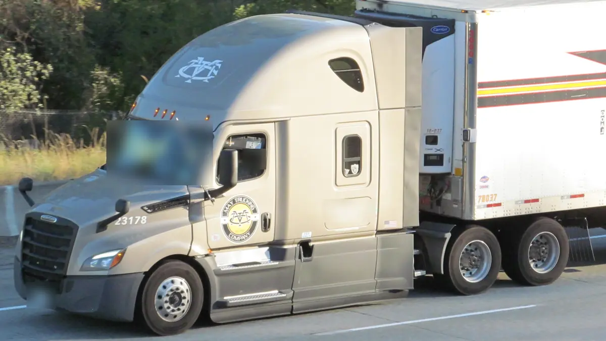 New-generation Freightliner Cascadia sleeper pulling a refrigerated trailer on I-90